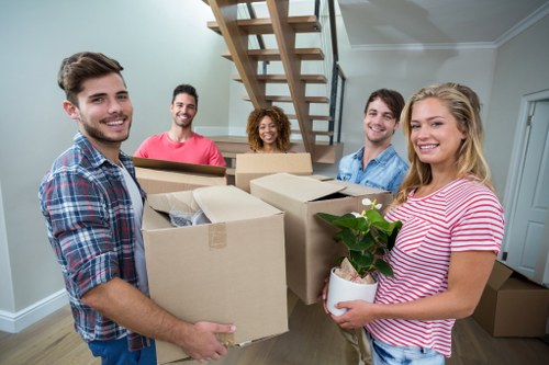 Professional movers packing boxes for a home relocation in Catford
