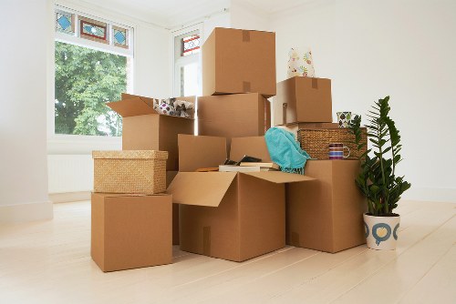 Professional removals team unloading boxes at a Catford home