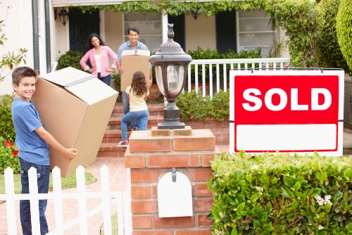 Professional movers carrying household items during a local Catford relocation
